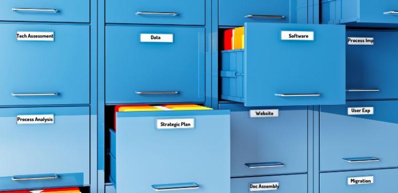 A wall of blue filing cabinets, some of them open with files within