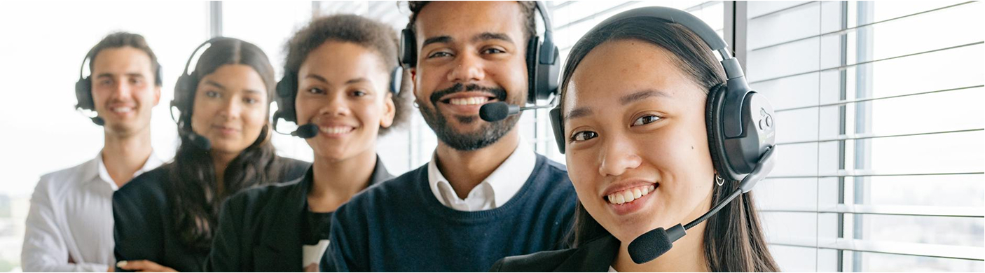 a row of happy people with phone call headsets standing in a row 