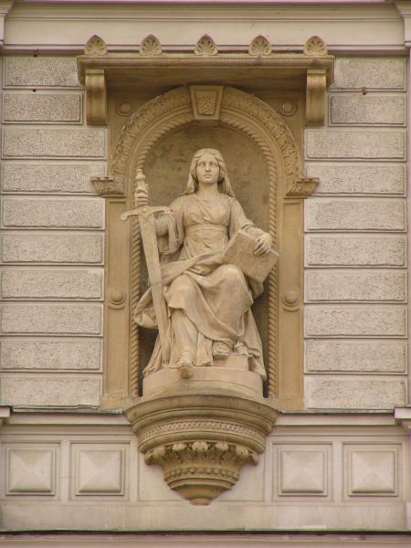Statue of seated woman holding a sword