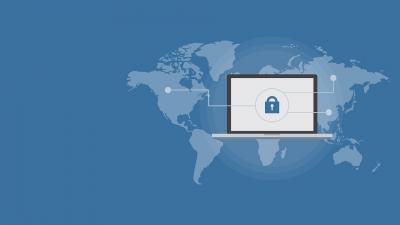 image of a laptop with a padlock on the screen superimposed over a map of the world