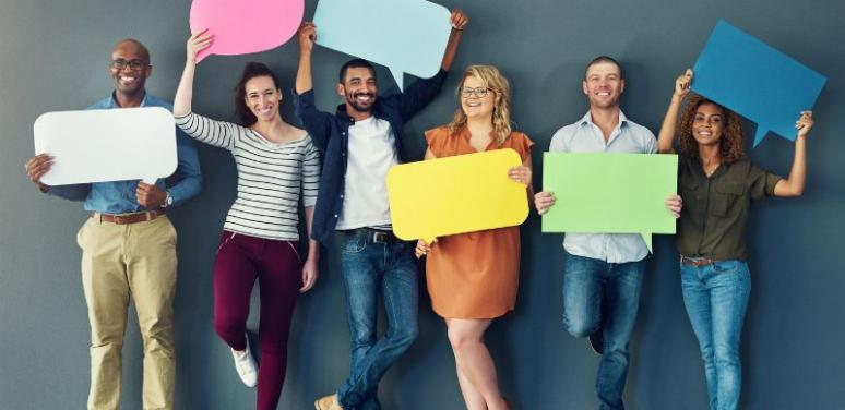 A group of people holding posters in the shape of text bubbles